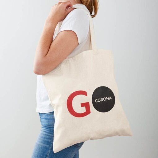 A woman holding a Go Corona Shopping Tote Bag.